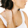 Minimalist kite bracelet inspired by comets in silver on woman's wrist