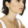 Woman wearing minimalist kite necklace in sterling silver
