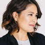 Woman wearing minimalist white gold bar earrings