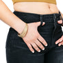 Woman wearing set of gold minimalist bangles