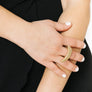 Woman wearing statement crescent moon ring in gold