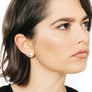 Woman wearing minimalist gold full moon earrings
