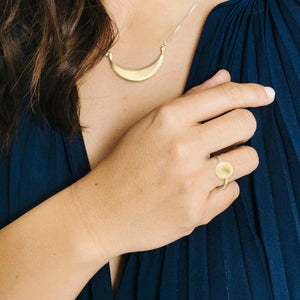 Woman wearing minimalist gold full moon ring with crescent moon necklace