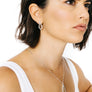 Woman wearing minimalist kite shaped earrings in sterling silver